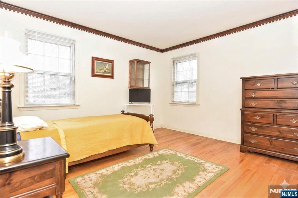 40 Hering Road Montvale, NJ 07645 - Photo 19 of 29 a bedroom with a bed and wooden floor
