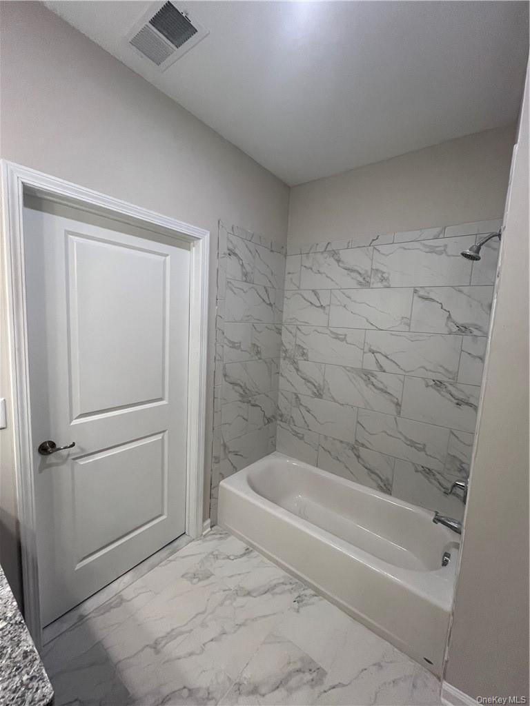 422 Tower Ridge Circle, Unit 422 Middletown, NY 10941 - Photo 4 of 17 a bathroom with a bathtub and a shower