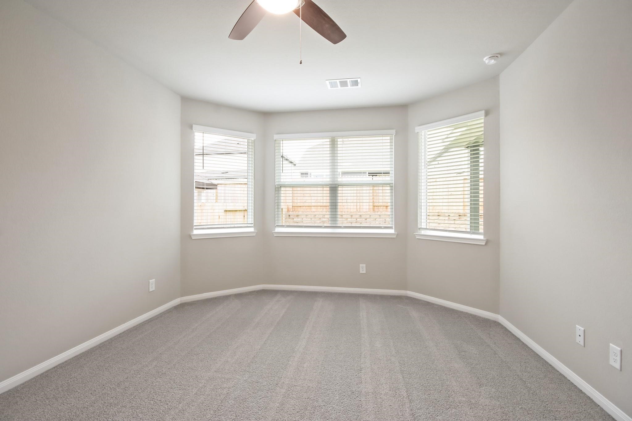 2416 Bluefish Court Conroe, TX 77384 - Photo 7 of 45 an empty room with windows and closet
