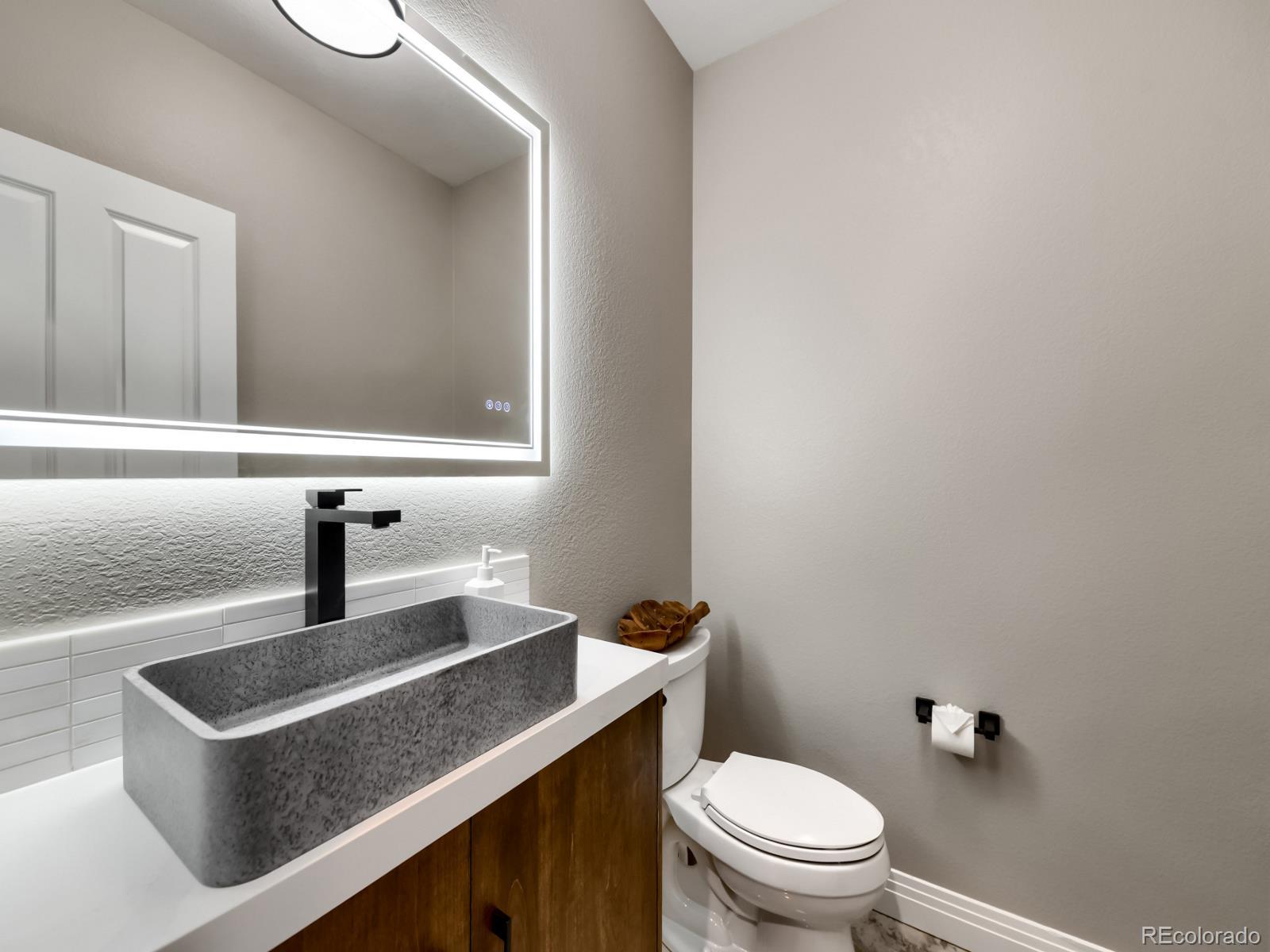 730 Genesee Mountain Road Golden, CO 80401 - Photo 35 of 50 a bathroom with a sink a toilet and mirror