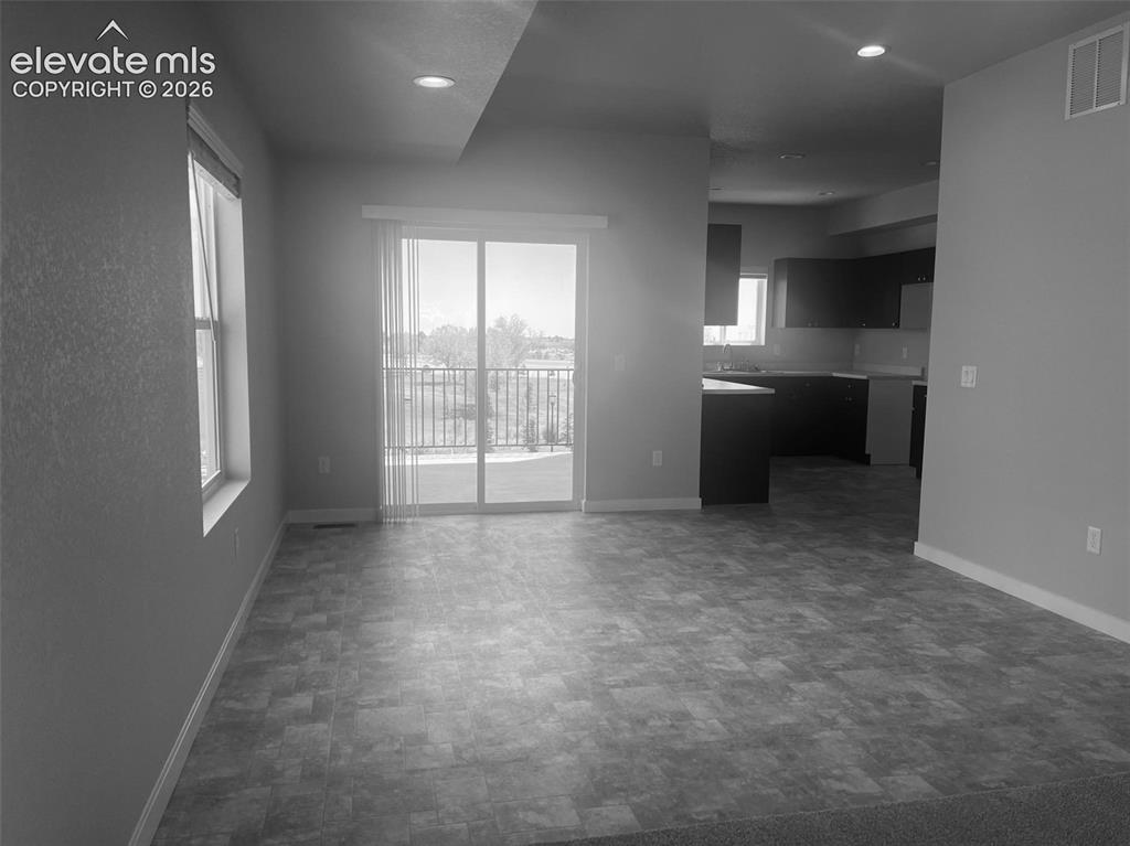 6644 Rawhide Rdg View Colorado Springs, CO 80915 - Photo 9 of 26 an empty room with windows and pillars in it