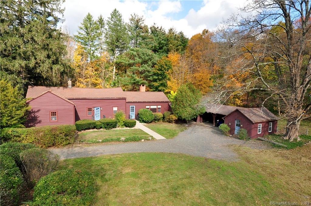 402 Bushy Hill Road Simsbury, CT 06070 - Photo 1 of 1 an aerial view of a house with yard and large trees