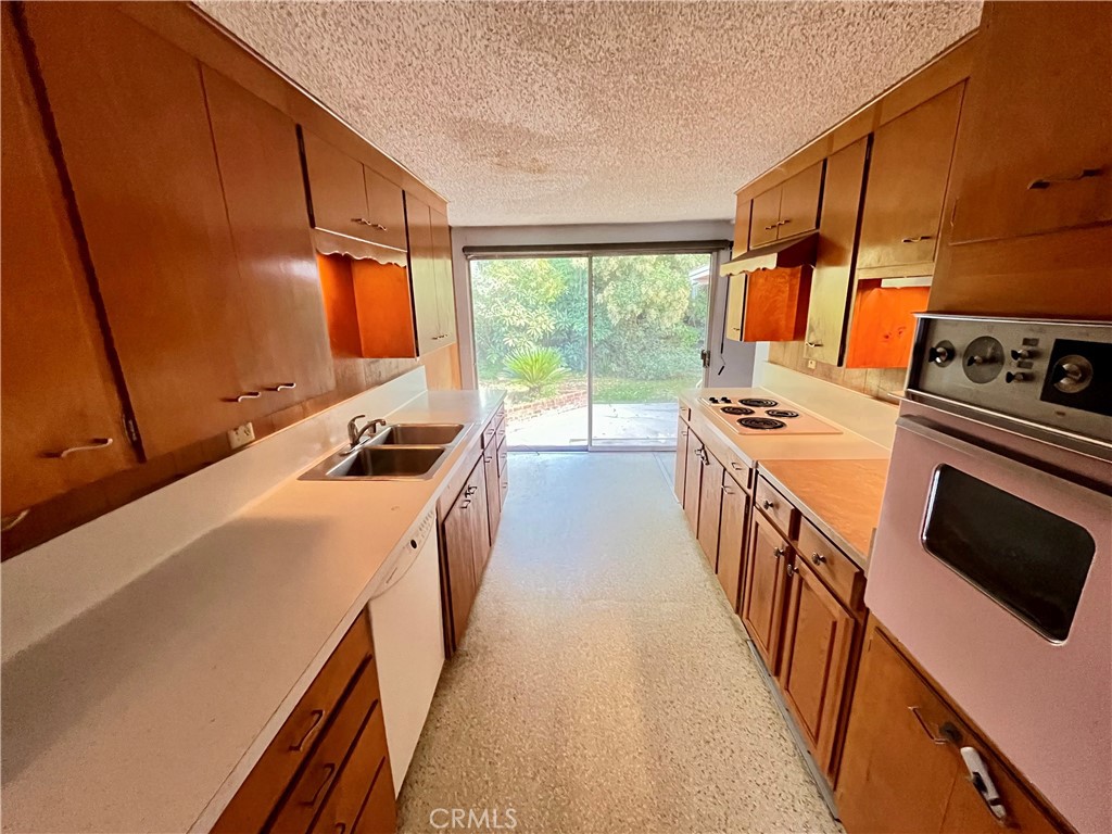4245-4245 Homewood Court Riverside, CA 92506 - Photo 4 of 15 a kitchen with a stove a sink and a refrigerator