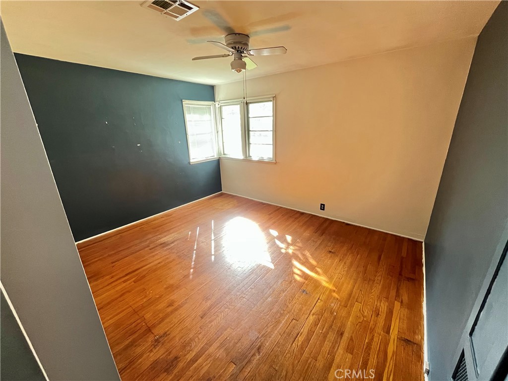 4245-4245 Homewood Court Riverside, CA 92506 - Photo 10 of 15 wooden floor in an empty room with a window
