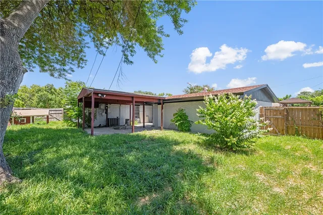 a view of house with backyard