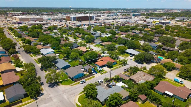 an aerial view of residential houses with outdoor space