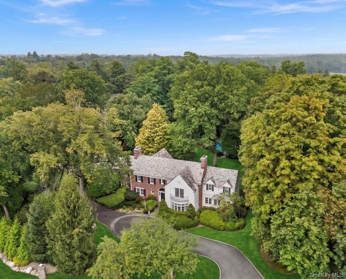 An elegant colonial estate nestled within lush, mature specimen trees and manicured grounds.Virtually enhanced grass.