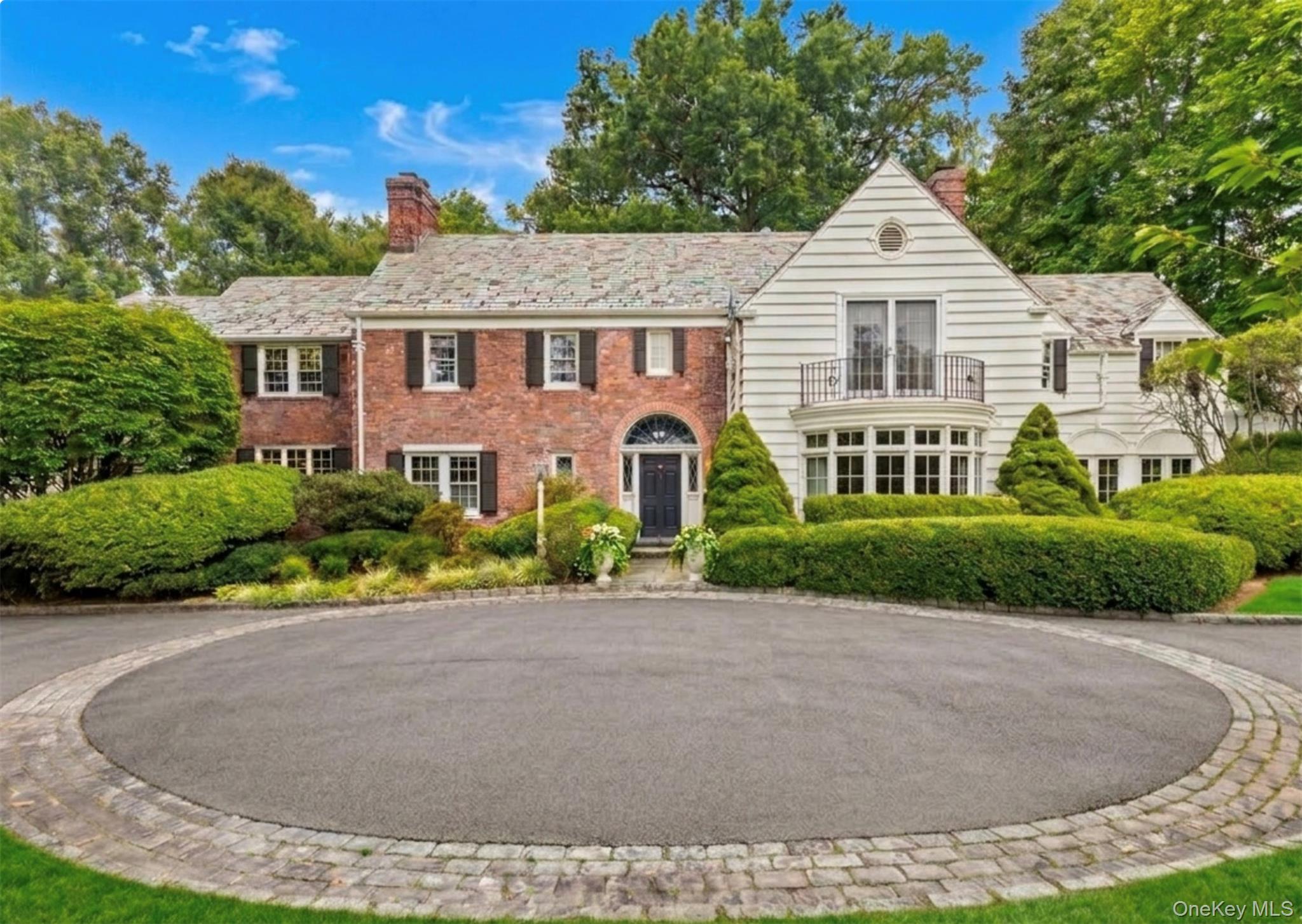2 Park Drive South Rye, NY 10580 - Photo 2 of 6 Stately brick and clapboard manor featuring a slate roof and a classic circular Belgian block driveway.Planters/grass virtually enhanced.
