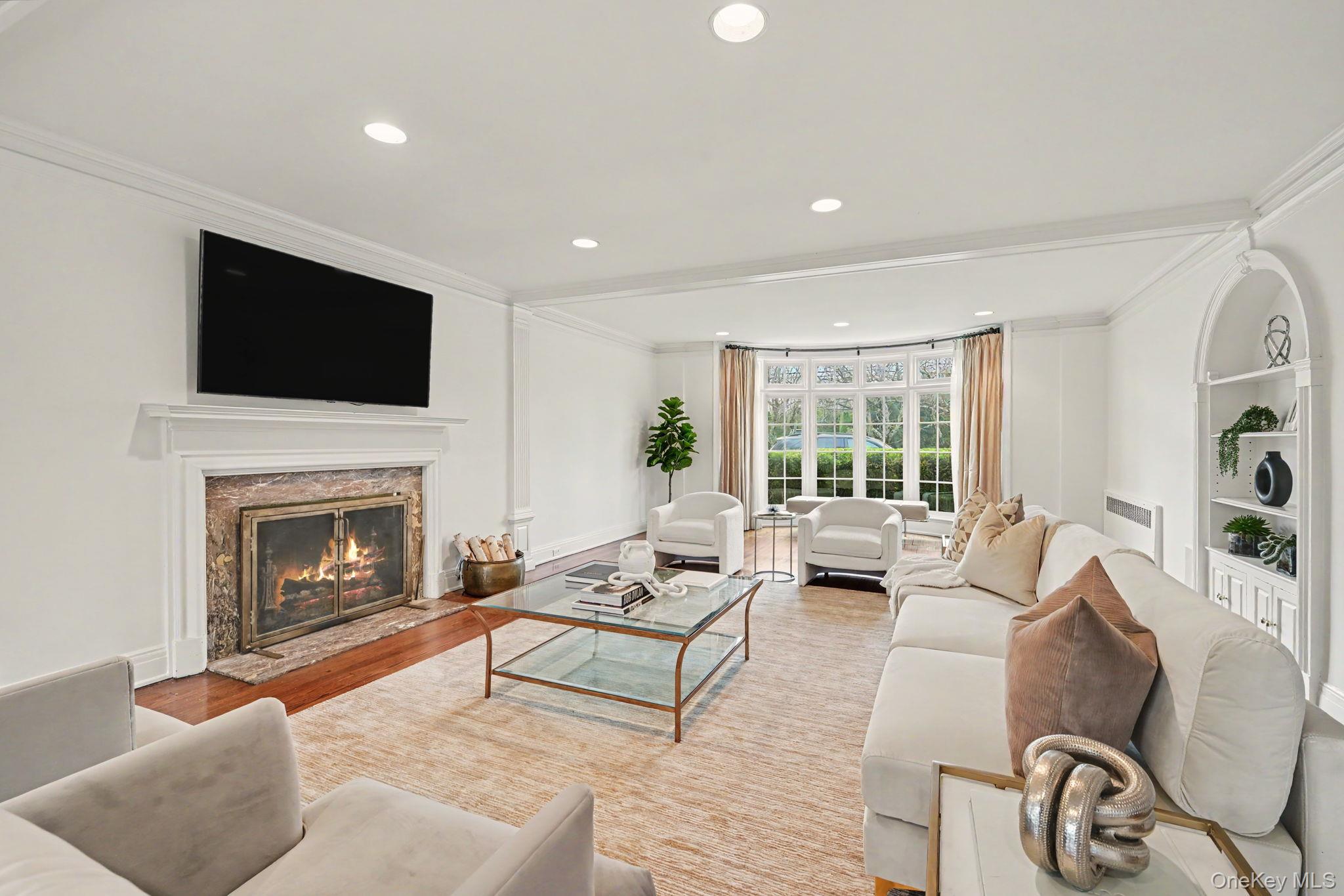 2 Park Drive South Rye, NY 10580 - Photo 6 of 50 a living room with furniture a flat screen tv and a fireplace