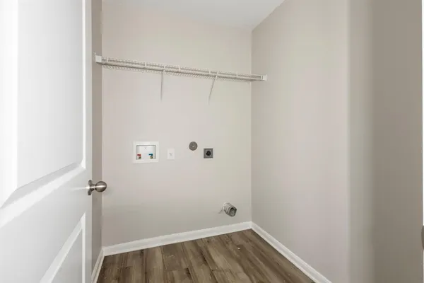 a view of a room with wooden floor