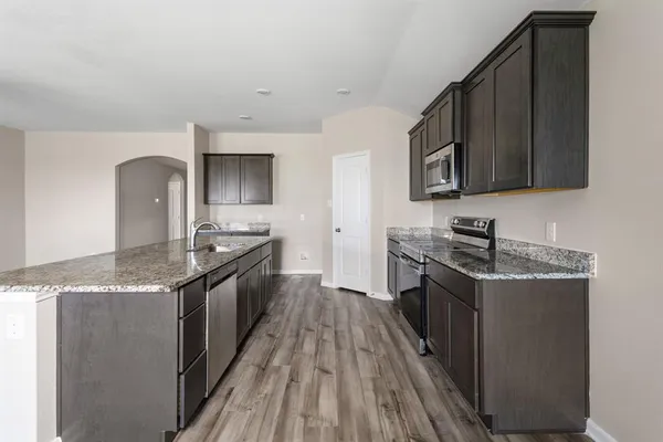 a kitchen with stainless steel appliances granite countertop a stove and a sink
