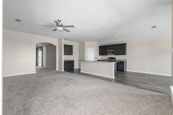 a view of a kitchen with a sink and a fireplace