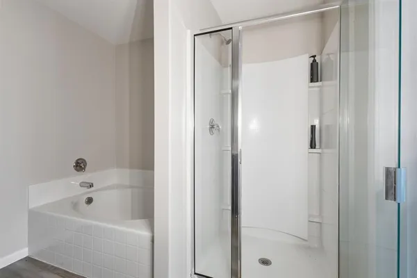a bathroom with a bathtub and a shower