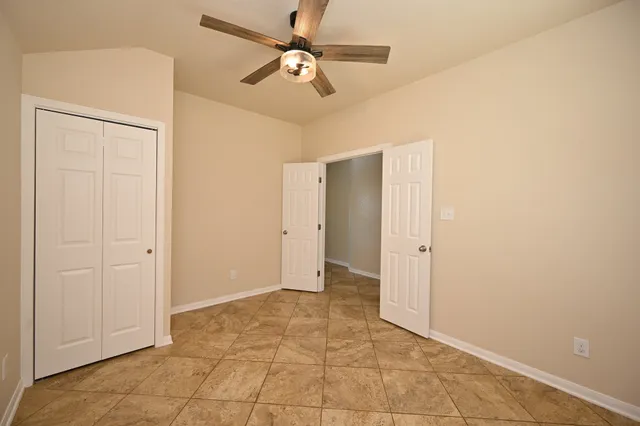 a view of a kitchen with a sink and a chandelier fan