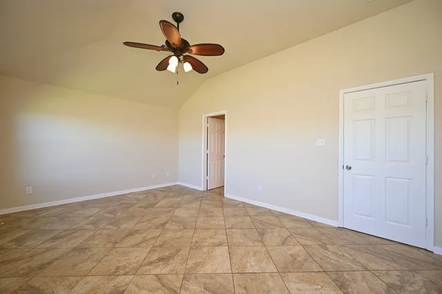 a bathroom with a granite countertop sink and a toilet