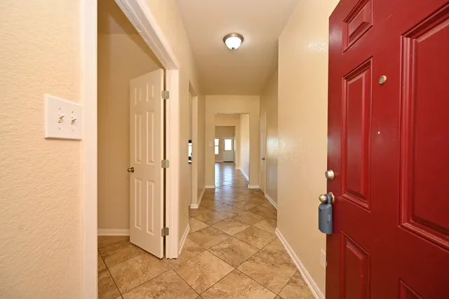 a kitchen with granite countertop a sink stove and refrigerator