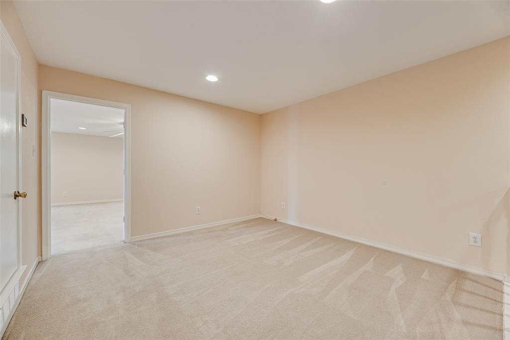 4988 Thunder Road Dallas, TX 75244 - Photo 24 of 32 Neutral-toned carpeting and walls create a versatile interior space with recessed lighting