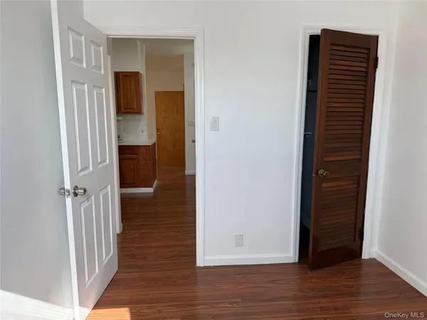 a view of hallway with wooden floor