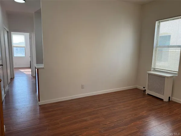 a view of a room with wooden floors and a window