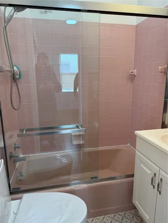 a bathroom with a shower and a toilet