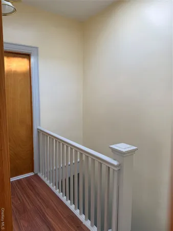 a view of hallway with wooden floor