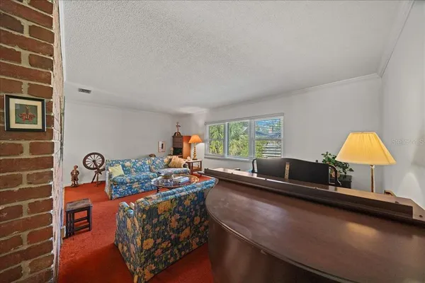 a living room with furniture a rug and a chandelier