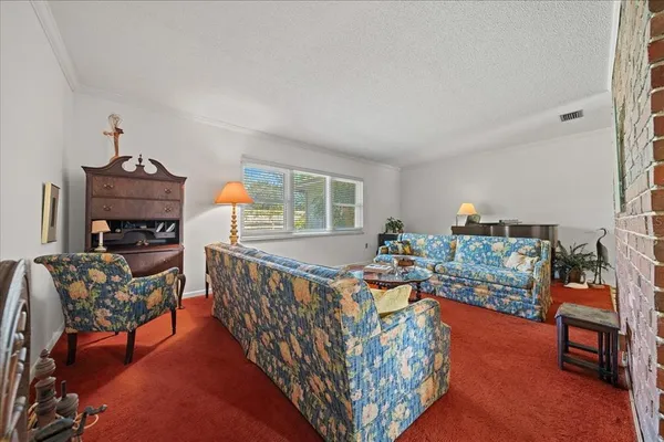 a living room with furniture and a rug