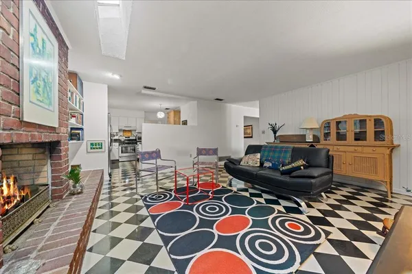 a living room with furniture and a book shelf