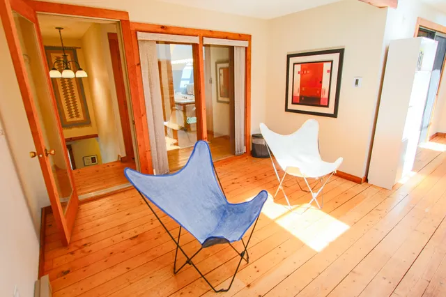 a view of a living room with a hardwood floor and furniture