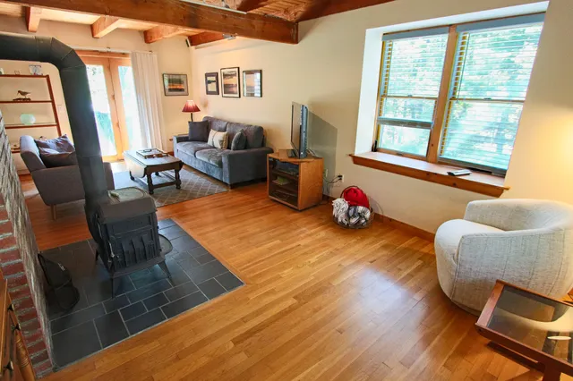 a living room with furniture rug and a large window