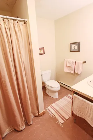 a spacious bedroom with a bed and a window