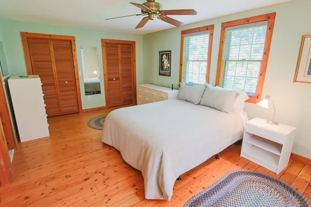 a spacious bedroom with a bed and a window