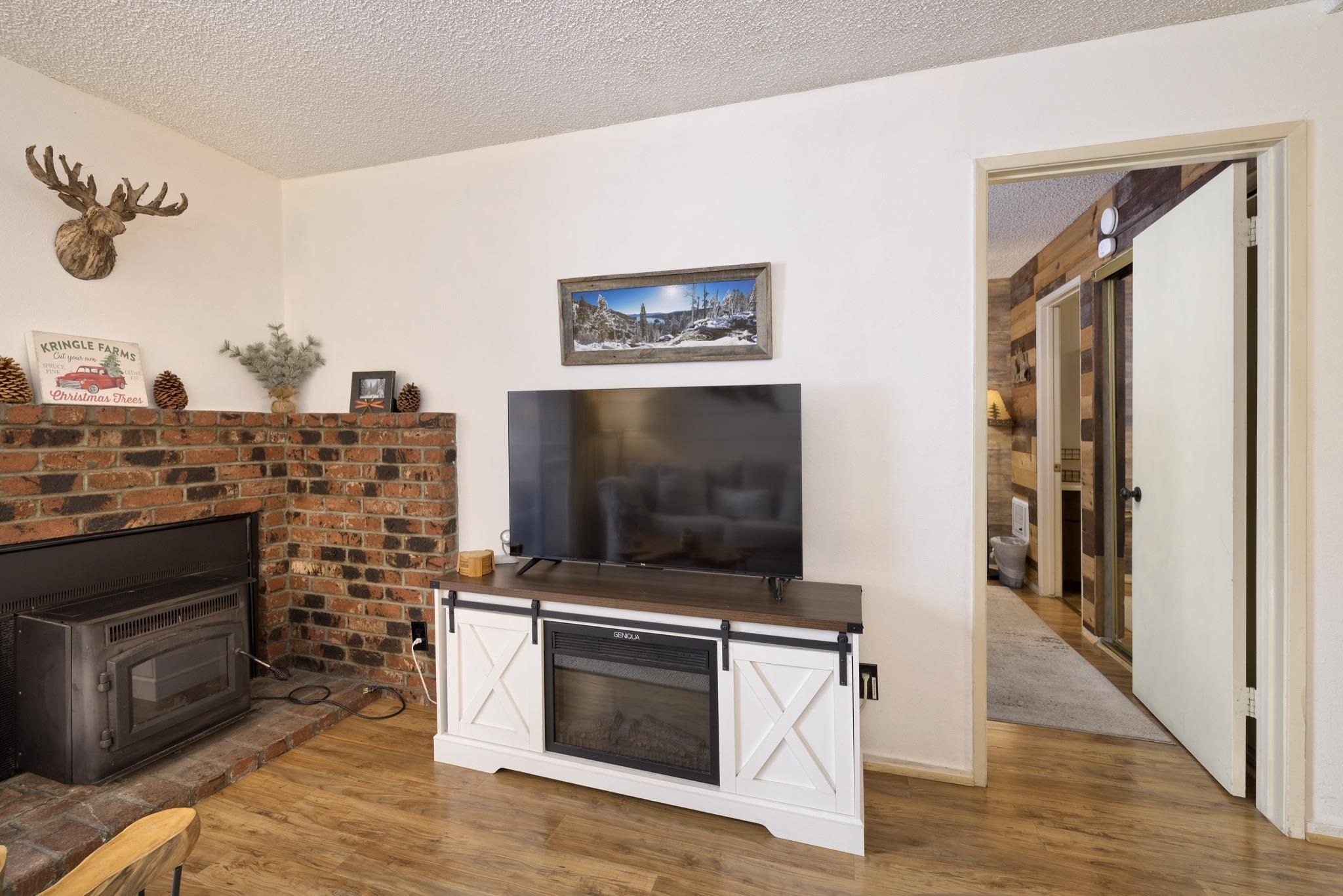 2499 Sierra Nevada Road, Unit R2 Mammoth Lakes, CA 93546 - Photo 13 of 26 a living room with stainless steel appliances furniture a fireplace and a flat screen tv