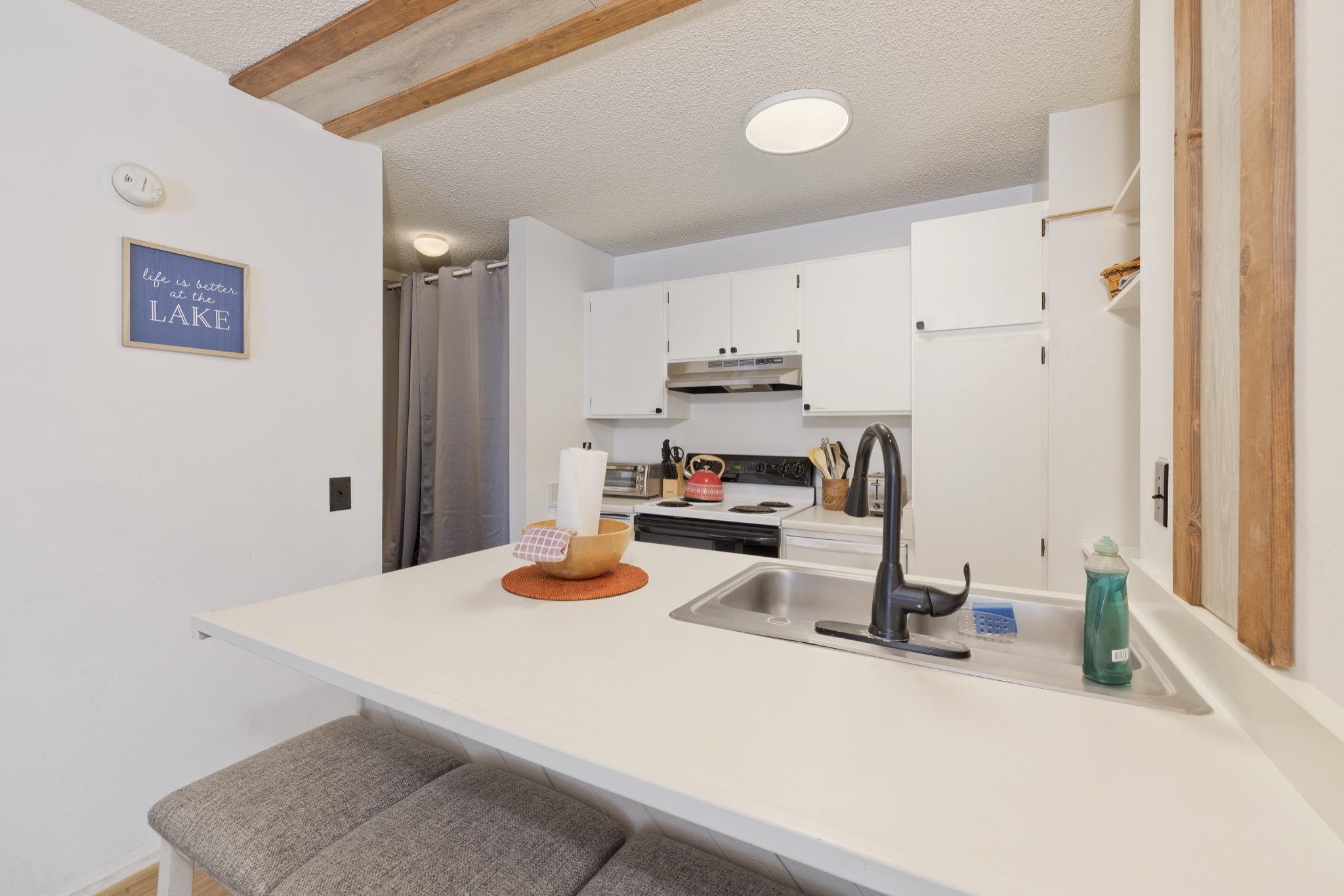 2499 Sierra Nevada Road, Unit R2 Mammoth Lakes, CA 93546 - Photo 15 of 26 a kitchen with a sink a stove and chairs