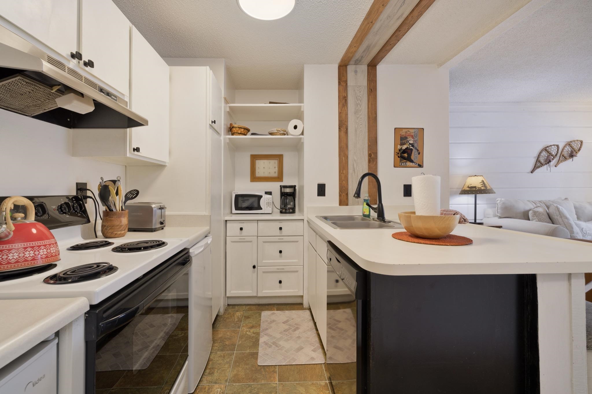 2499 Sierra Nevada Road, Unit R2 Mammoth Lakes, CA 93546 - Photo 25 of 26 a kitchen with a sink a stove and cabinets