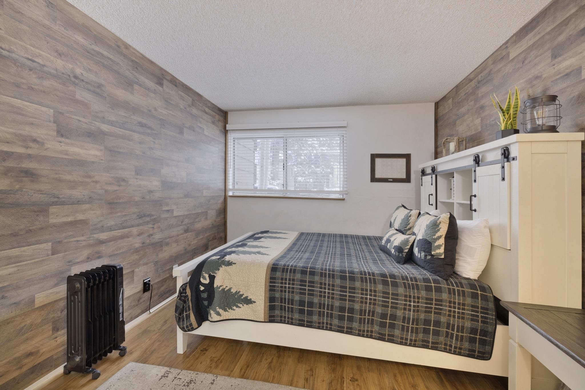 2499 Sierra Nevada Road, Unit R2 Mammoth Lakes, CA 93546 - Photo 18 of 26 a bedroom with a bed and wooden floor