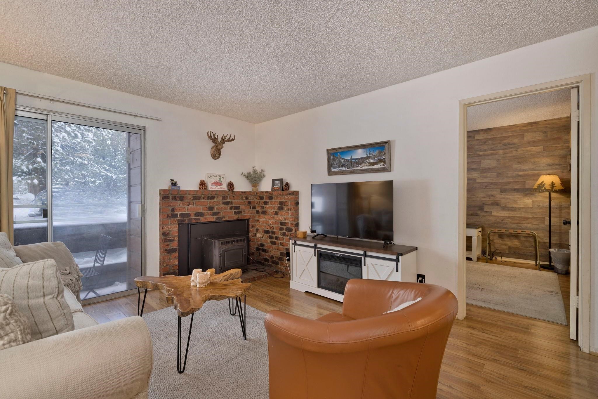 2499 Sierra Nevada Road, Unit R2 Mammoth Lakes, CA 93546 - Photo 6 of 26 a living room with furniture a flat screen tv and a fireplace