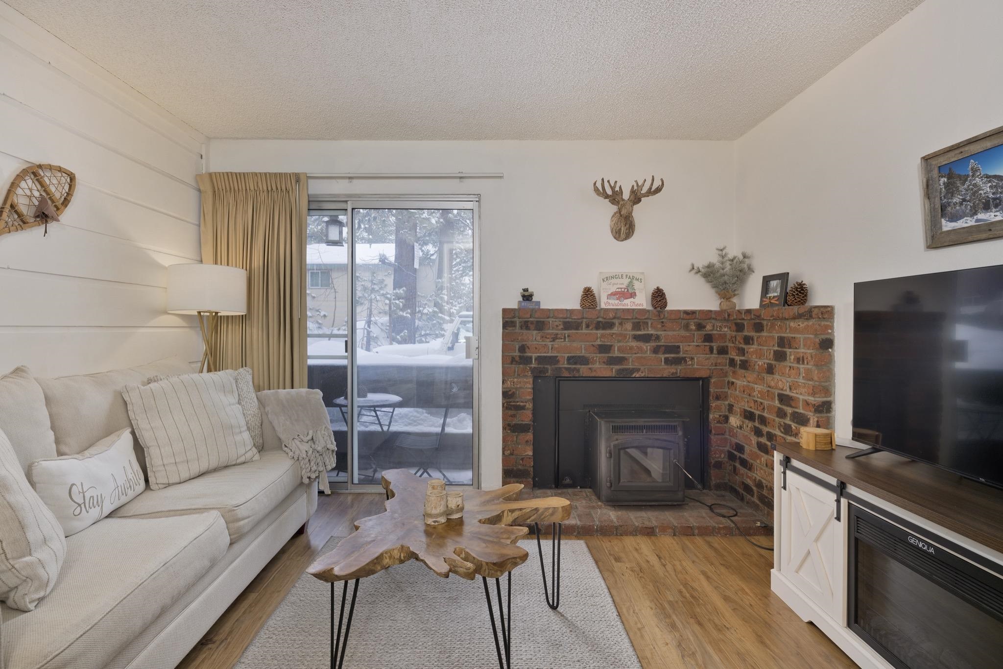 2499 Sierra Nevada Road, Unit R2 Mammoth Lakes, CA 93546 - Photo 7 of 26 a living room with furniture a flat screen tv and a fireplace