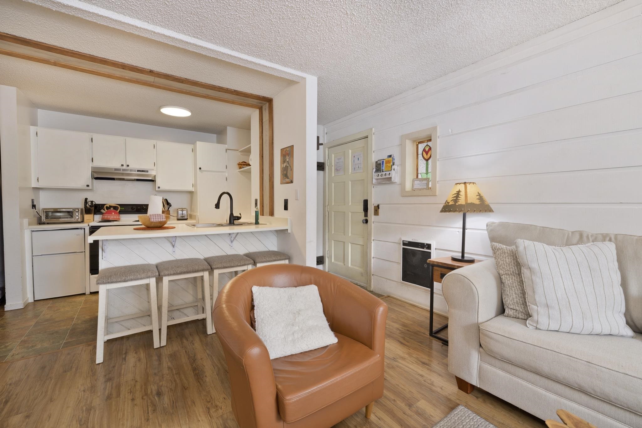 2499 Sierra Nevada Road, Unit R2 Mammoth Lakes, CA 93546 - Photo 10 of 26 a living room with furniture and a wooden floor