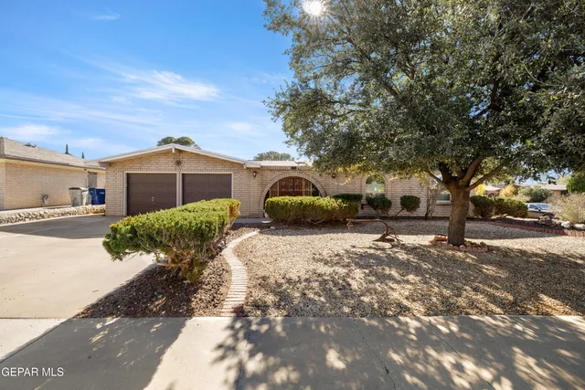 a yellow house with trees in front of it