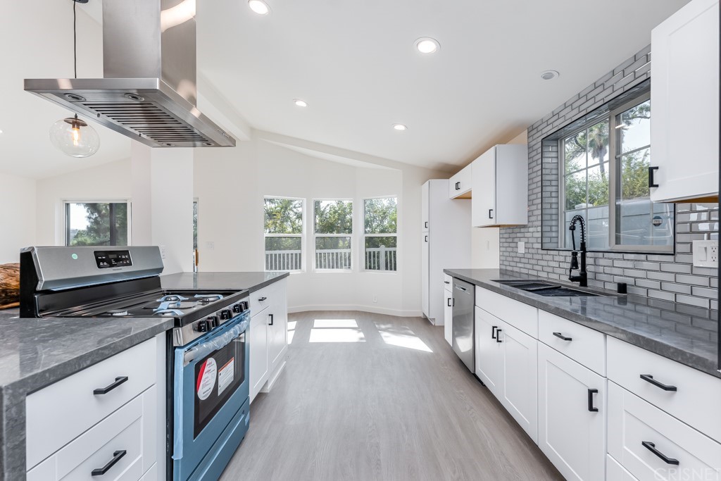 1177 Aztec Topanga, CA 90290 - Photo 11 of 65 a kitchen with stainless steel appliances granite countertop a stove and a sink