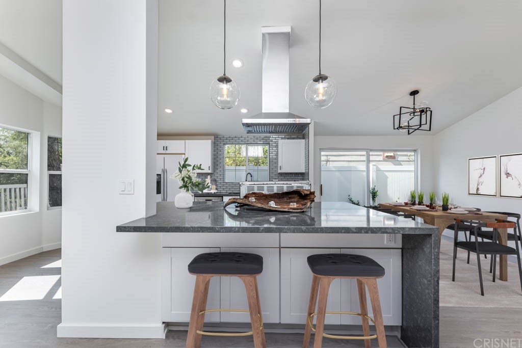 1177 Aztec Topanga, CA 90290 - Photo 13 of 65 a kitchen with kitchen island granite countertop a table chairs sink and cabinets