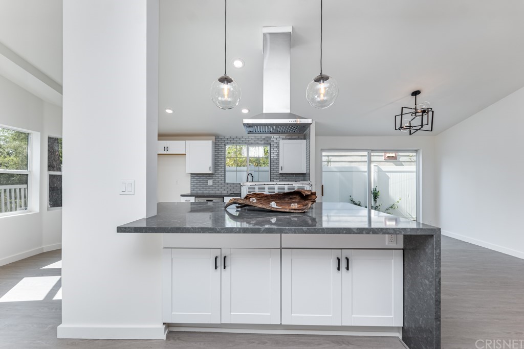 1177 Aztec Topanga, CA 90290 - Photo 14 of 65 a kitchen with granite countertop a sink and white cabinets