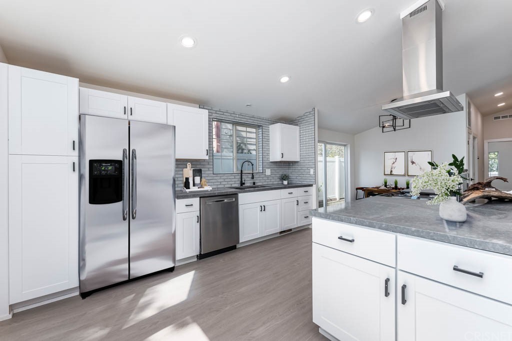 1177 Aztec Topanga, CA 90290 - Photo 15 of 65 a kitchen with white cabinets and white appliances