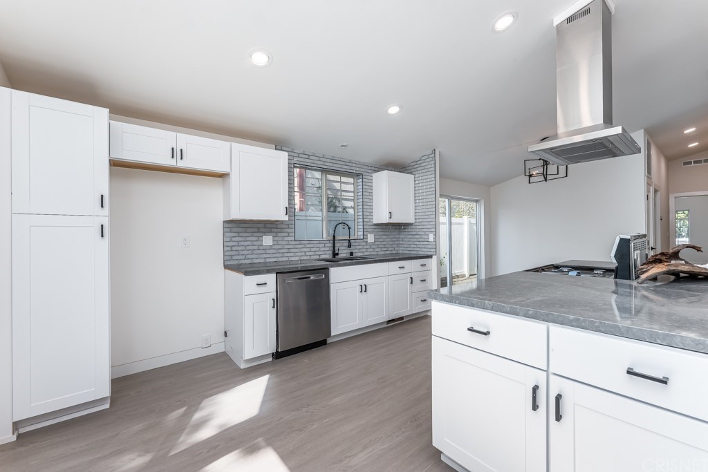 1177 Aztec Topanga, CA 90290 - Photo 16 of 65 a kitchen with a sink a stove a refrigerator and white cabinets