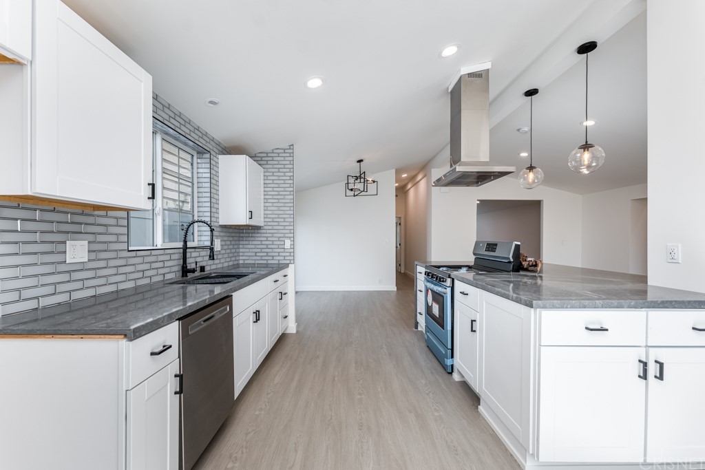 1177 Aztec Topanga, CA 90290 - Photo 17 of 65 a kitchen with stainless steel appliances granite countertop a sink a stove and a wooden floors