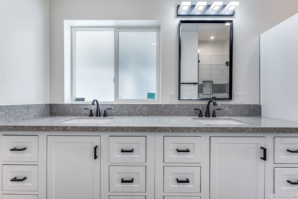 1177 Aztec Topanga, CA 90290 - Photo 27 of 65 a bathroom with white cabinets and a sink
