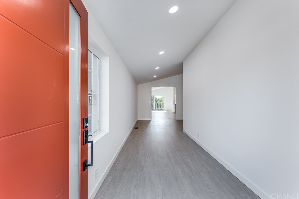 1177 Aztec Topanga, CA 90290 - Photo 3 of 65 a view of a hallway with wooden floor