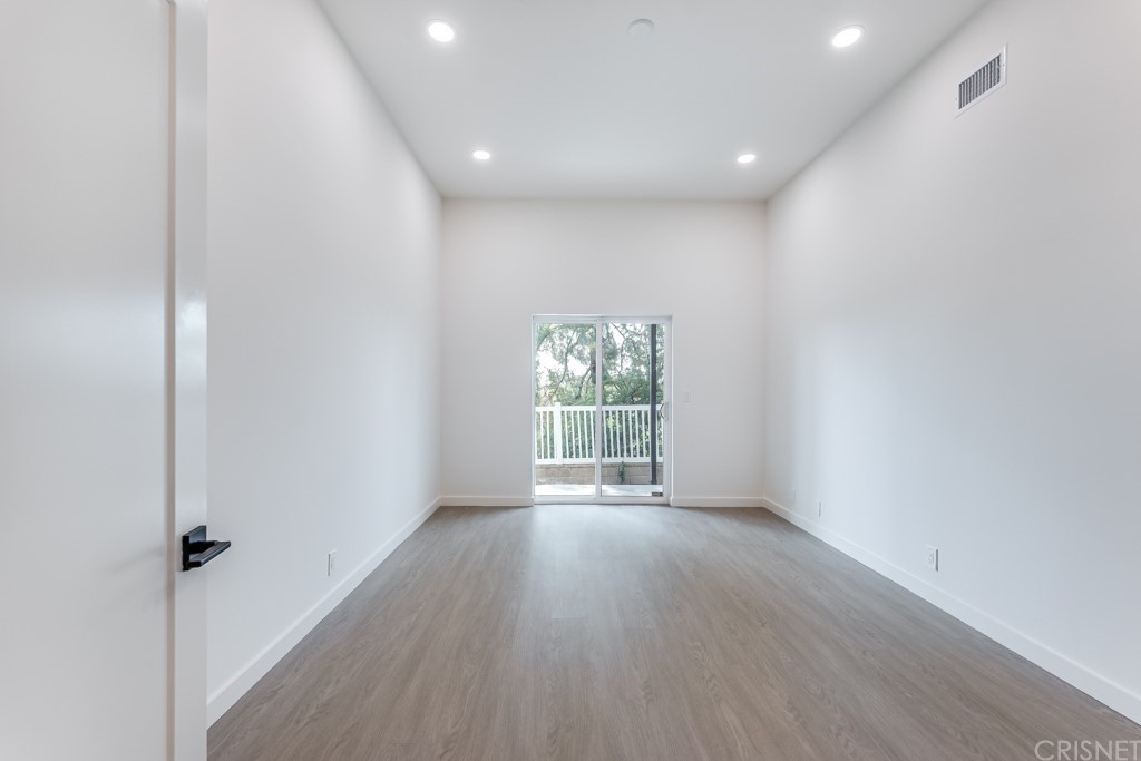 1177 Aztec Topanga, CA 90290 - Photo 31 of 65 a view of an empty room with wooden floor and a window