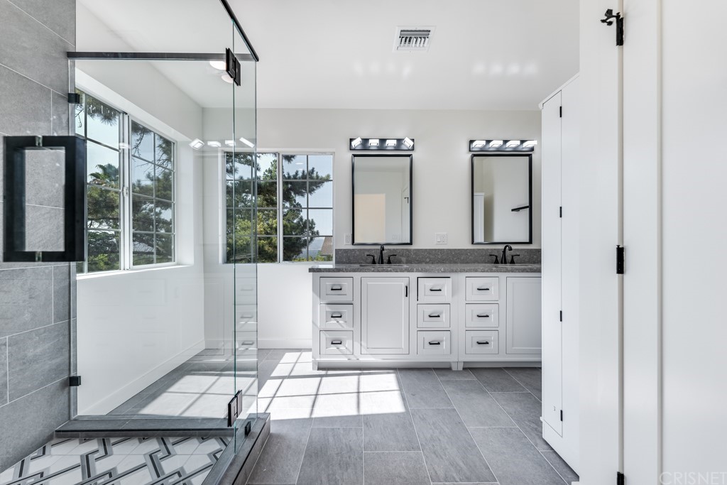 1177 Aztec Topanga, CA 90290 - Photo 39 of 65 a spacious bathroom with a double vanity sink a mirror and a shower